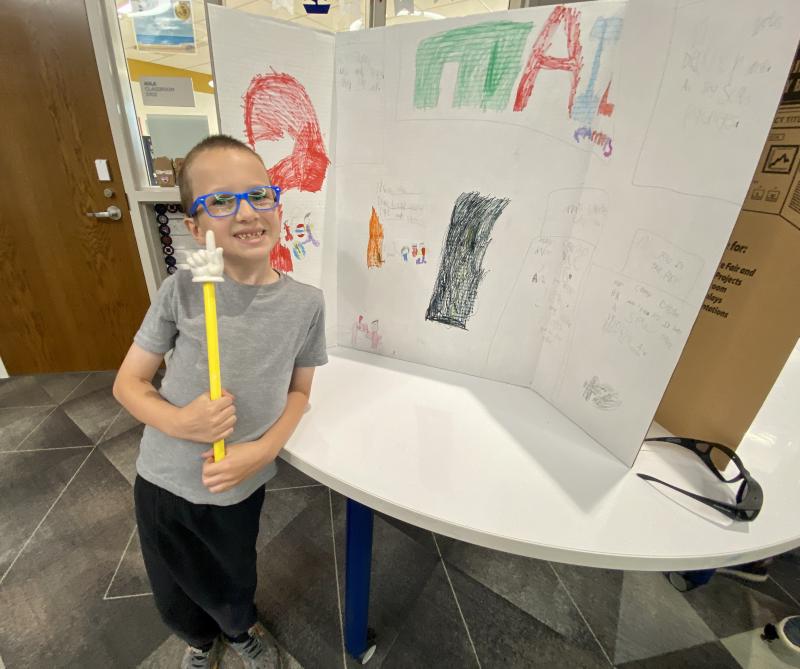 Second-grader Liam Bayless even uses a pointer to depict the job of a mail carrier.